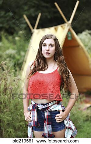 Serious woman standing at camping tent View Large Photo Image Stock Image - Serious woman standing at camping tent. Fotosearch