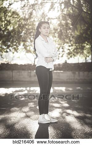 Serious woman standing outdoors View Large Photo Image Stock Photograph - Serious woman standing outdoors. Fotosearch