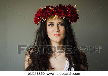 Stock Image - Serious woman wearing flower crown. Fotosearch
