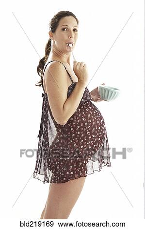 Side view of pregnant woman eating from bowl View Large Photo Image Stock Photo - Side view of pregnant woman eating from bowl. Fotosearch