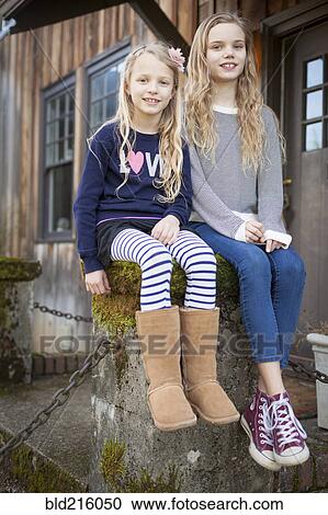 Sisters sitting on mossy pedestal View Large Photo Image Stock Image - Sisters sitting on mossy pedestal. Fotosearch
