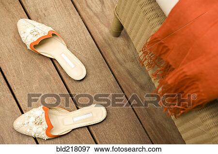 Stock Photo - Slippers on wooden floor. Fotosearch