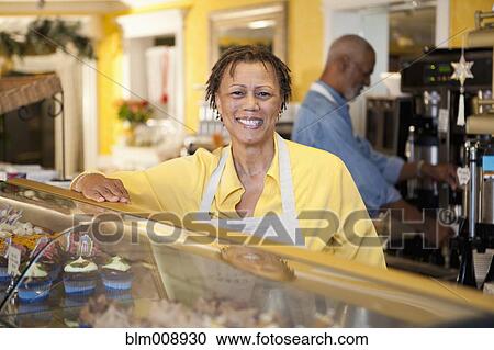 Small business owners working in bakery together View Large Photo Image Stock Image - Small business owners working in bakery together. Fotosearch