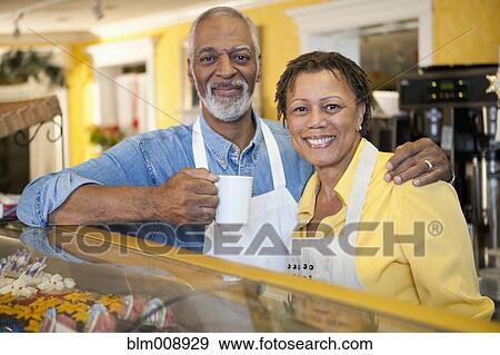 Small business owners working in bakery together View Large Photo Image Stock Photo - Small business owners working in bakery together. Fotosearch
