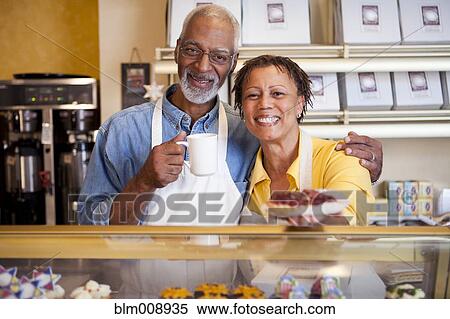 Stock Photography - Small business owners working in bakery together. Fotosearch