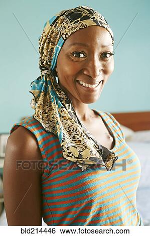 Stock Photograph - Smiling African American woman wearing headscarf. Fotosearch