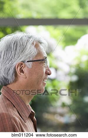 Picture - Smiling Asian businessman. Fotosearch