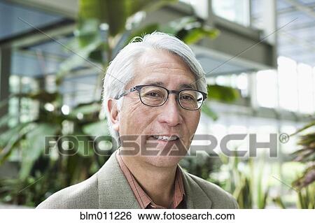 Stock Photograph - Smiling Asian businessman. Fotosearch