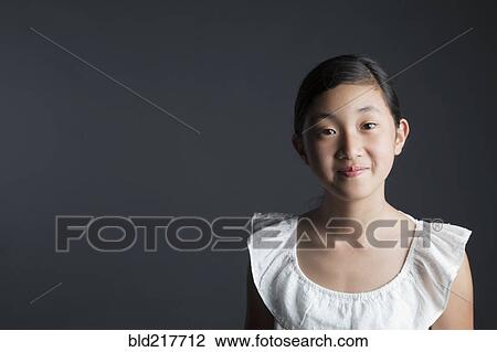 Stock Image - Smiling Asian girl looking at camera. Fotosearch