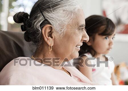 Stock Photo - Smiling Asian grandmother and granddaughter. Fotosearch