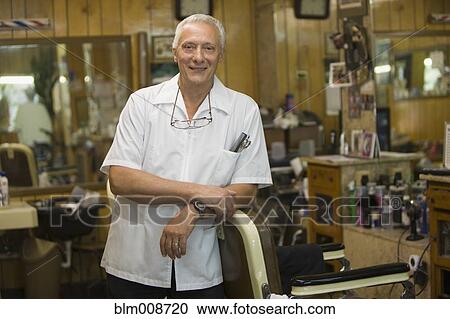 Smiling barber standing in barbershop View Large Photo Image Stock Image - Smiling barber standing in barbershop. Fotosearch