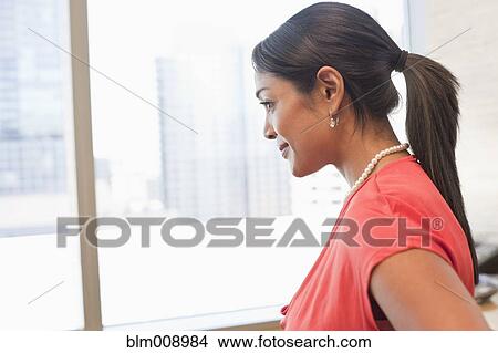 Picture - Smiling Black businesswoman standing in office. Fotosearch
