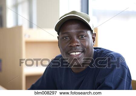 Smiling Black student in library View Large Photo Image Stock Photo - Smiling Black student in library. Fotosearch
