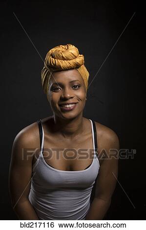 Smiling Black woman wearing headwrap View Large Photo Image Stock Photograph - Smiling Black woman wearing headwrap. Fotosearch
