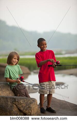 Smiling boys fishing together View Large Photo Image Stock Photo - Smiling boys fishing together. Fotosearch