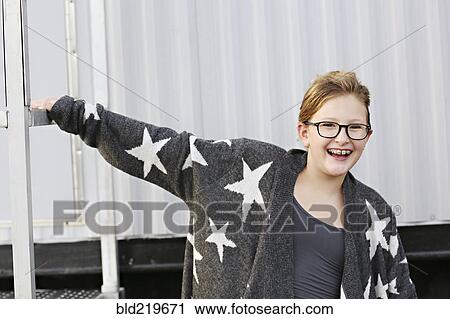 Stock Image - Smiling Caucasian girl standing outside trailer. Fotosearch