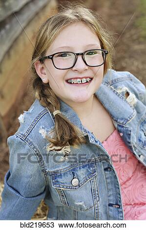 Smiling Caucasian girl with braces and eyeglasses View Large Photo Image Stock Image - Smiling Caucasian girl with braces and eyeglasses. Fotosearch