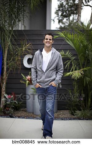 Stock Photography - Smiling Caucasian man walking outdoors. Fotosearch