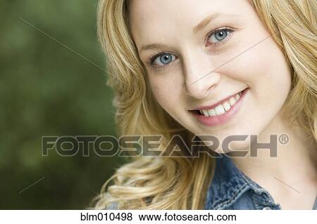 Stock Photo - Smiling Caucasian woman outdoors. Fotosearch