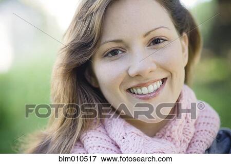 Stock Photo - Smiling Caucasian woman outdoors. Fotosearch
