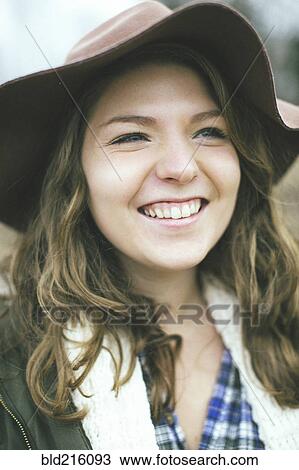 Stock Image - Smiling Caucasian woman wearing sun hat. Fotosearch