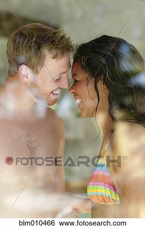 Smiling couple behind window View Large Photo Image Stock Photograph - Smiling couple behind window. Fotosearch