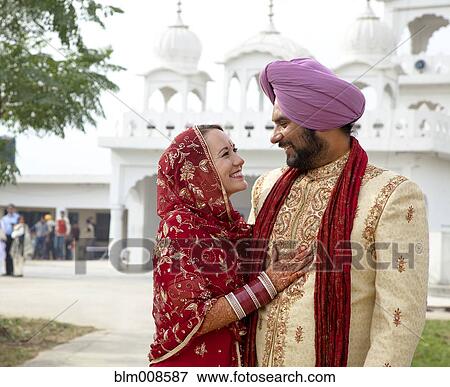 Smiling couple in traditional Indian clothing View Large Photo Image Stock Photo - Smiling couple in traditional Indian clothing. Fotosearch