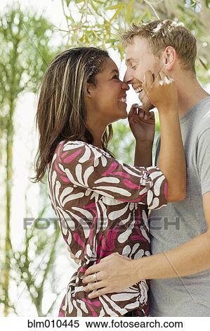 Smiling couple rubbing noses outdoors View Large Photo Image Stock Photography - Smiling couple rubbing noses outdoors. Fotosearch