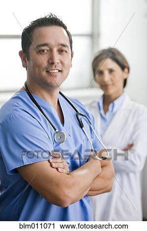 Stock Image - Smiling doctors standing together. Fotosearch