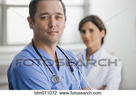 Smiling doctors standing together View Large Photo Image Stock Image - Smiling doctors standing together. Fotosearch