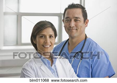 Smiling doctors standing together View Large Photo Image Stock Photo - Smiling doctors standing together. Fotosearch