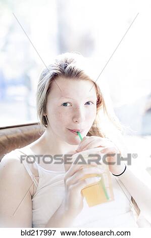Stock Photo - Smiling girl drinking iced tea. Fotosearch