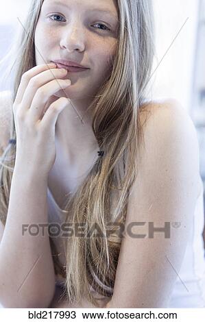 Smiling girl resting chin in hand View Large Photo Image Stock Image - Smiling girl resting chin in hand. Fotosearch