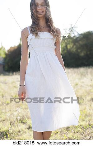 Smiling girl walking in field View Large Photo Image Stock Photography - Smiling girl walking in field. Fotosearch