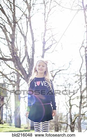 Smiling girl walking in park View Large Photo Image Stock Photo - Smiling girl walking in park. Fotosearch