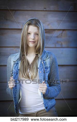 Stock Photo - Smiling girl wearing denim jacket. Fotosearch