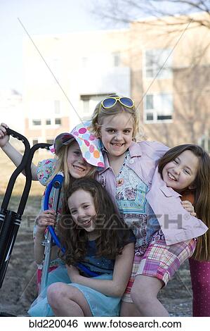 Stock Photograph - Smiling girls playing in park. Fotosearch