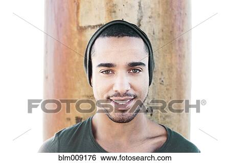 Stock Photograph - Smiling Hispanic man wearing cap. Fotosearch