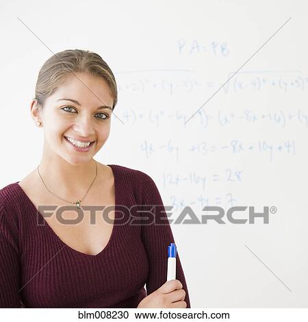 Smiling Indian student next to whiteboard in classroom View Large Photo Image Stock Image - Smiling Indian student next to whiteboard in classroom. Fotosearch