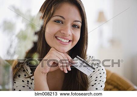 Smiling Indian woman holding credit card View Large Photo Image Stock Image - Smiling Indian woman holding credit card. Fotosearch