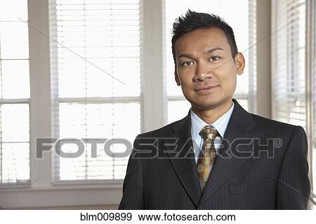 Stock Photo - Smiling Malaysian businessman in office. Fotosearch