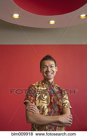 Smiling Malaysian man with arms crossed View Large Photo Image Stock Photo - Smiling Malaysian man with arms crossed. Fotosearch