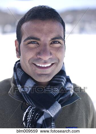 Smiling man standing in snow View Large Photo Image Stock Photo - Smiling man standing in snow. Fotosearch