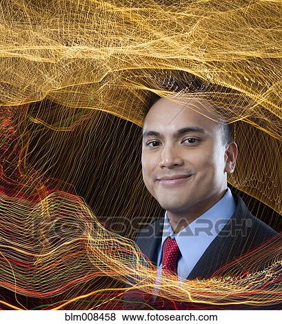 Smiling mixed race businessman surrounded by swirling lines View Large Photo Image Stock Photo - Smiling mixed race businessman surrounded by swirling lines. Fotosearch