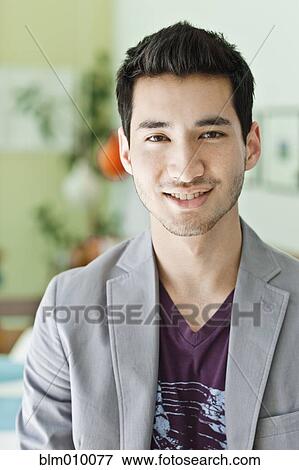Stock Photo - Smiling mixed race man in jacket. Fotosearch