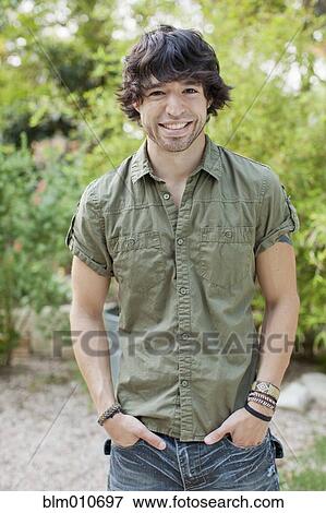 Smiling mixed race man with hands in pockets View Large Photo Image Stock Photo - Smiling mixed race man with hands in pockets. Fotosearch