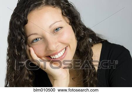 Smiling mixed race woman with head in hands View Large Photo Image Stock Image - Smiling mixed race woman with head in hands. Fotosearch