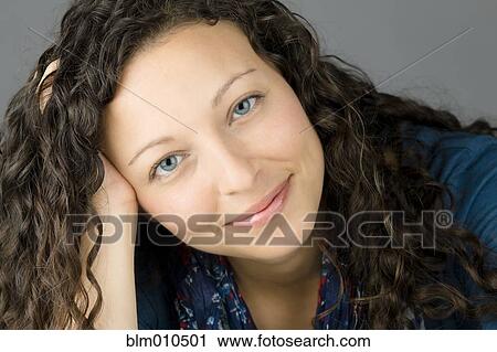 Smiling mixed race woman with head in hands View Large Photo Image Stock Image - Smiling mixed race woman with head in hands. Fotosearch