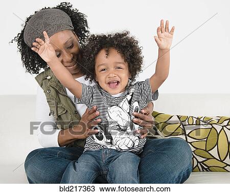 Smiling mother hugging cheering son View Large Photo Image Stock Image - Smiling mother hugging cheering son. Fotosearch