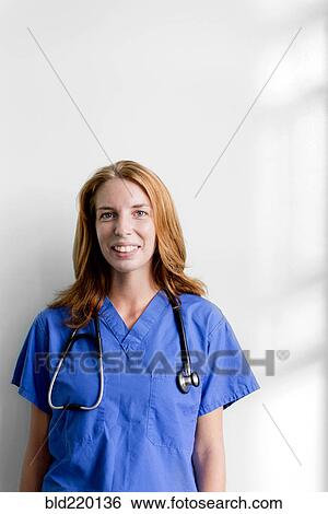 Stock Photograph - Smiling nurse wearing stethoscope. Fotosearch